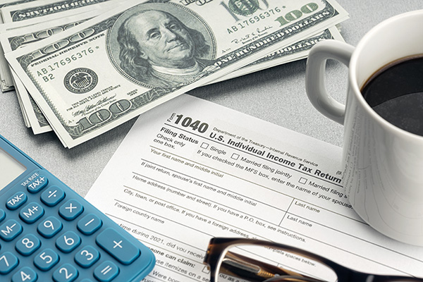 Tax form placed next to a calculator and cash